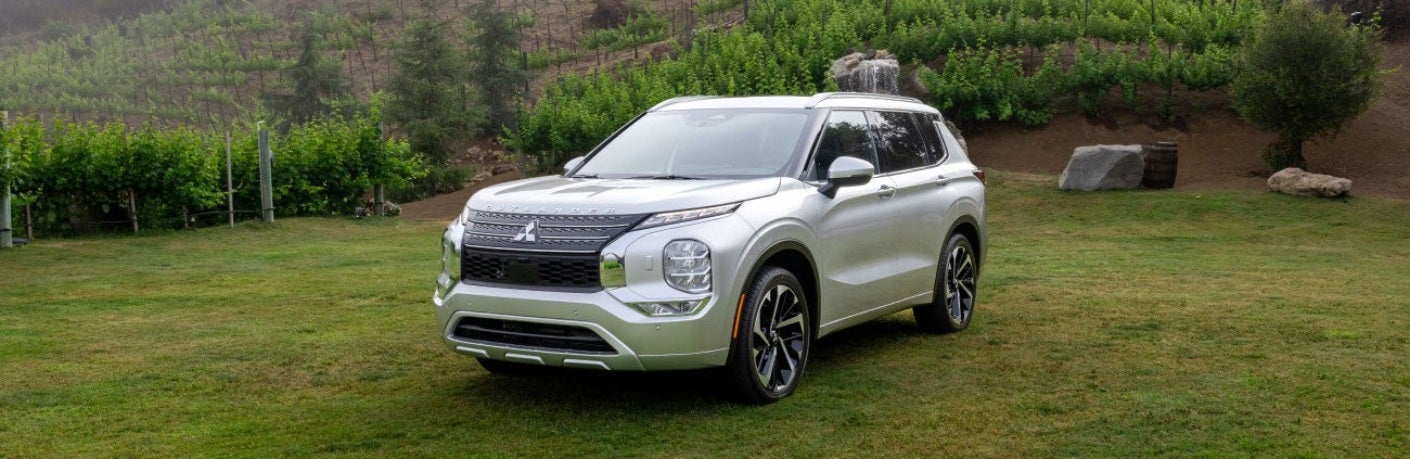 Silver 2024 Mitsubishi Outlander Parked in Grass