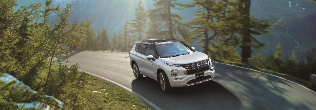 2023 Mitsubishi Outlander PHEV Driving Through Forest on Road