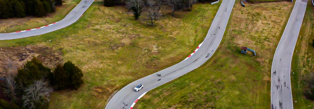 White Mitsubishi Outlander PHEV on Winding Racetrack