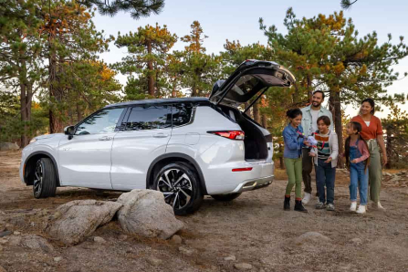 Family Standing Outside Mitsubishi Outlander Plug-In Hybrid with Liftgate Open