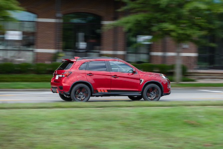 Side Profile of Red 2023 Outlander Sport Driving on Road